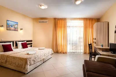 a bedroom with a bed and a desk and a computer at Hotel St Valentine all inclusive in Sunny Beach