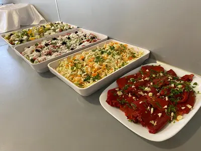 three trays of different types of food on a table at Hotel Sea Star Приморско in Primorsko