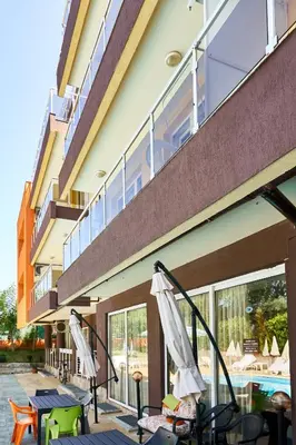 a building with a balcony and a swimming pool at Hotel Sea Star Приморско in Primorsko