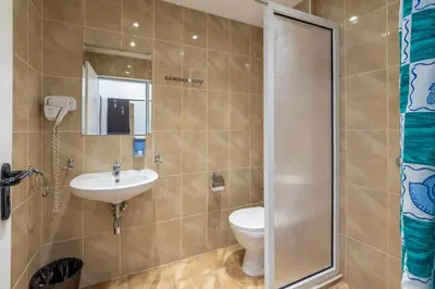 a bathroom with a toilet and a sink at Midia Family Resort All-Inclusive in Aheloy