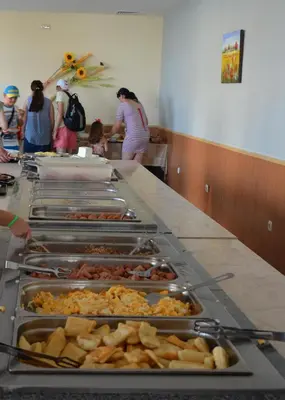a buffet with many trays of food on a table at Midia Family Resort All-Inclusive in Aheloy