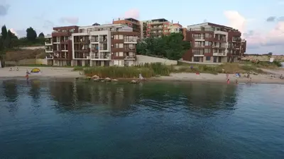 a group of buildings on a beach next to a body of water at Akrotiria Beach Apart Complex in Nesebar