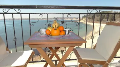 a bowl of fruit on a table on a balcony at Akrotiria Beach Apart Complex in Nesebar