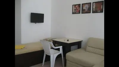 a room with a desk and a chair and a table at GoodRest Nesebar in Nesebar