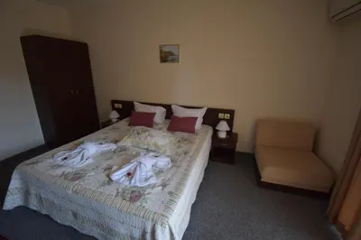 a bedroom with a bed with towels on it at Kandrovi Sozopol in Sozopol