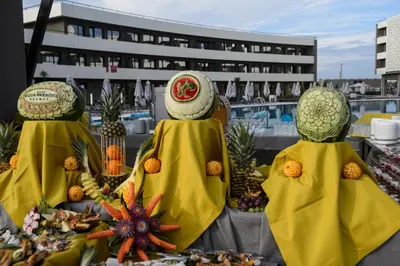 three figurines of people in towels with fruit on a table at Aqua Paradise Resort & Aqua Park in Nesebar