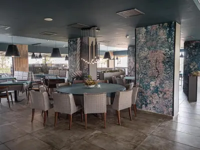 a dining room with a table and chairs at Aqua Paradise Resort & Aqua Park in Nesebar