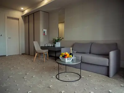a living room with a couch and a table at Aqua Paradise Resort & Aqua Park in Nesebar