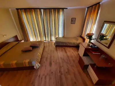a hotel room with two beds and a large window at Hotel Veris in Sunny Beach