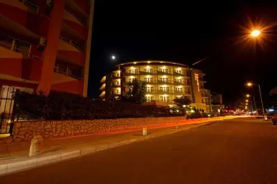 a building on the side of a street at night at Hotel Veris in Sunny Beach
