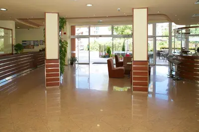 a lobby with chairs and tables in a building at Hotel Veris in Sunny Beach