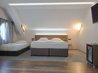 a bedroom with two beds in a room at Hugo Hotel in Varna City