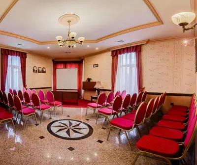 a conference room with red chairs and a whiteboard at Boutique Splendid Hotel in Varna City