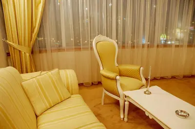 a living room with a couch and a table at Mirage Hotel in Burgas City