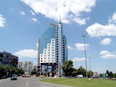 a tall glass building with a antenna on top of it at Mirage Hotel in Burgas City