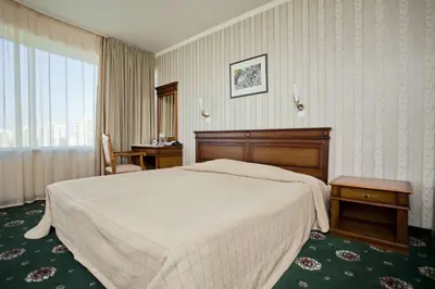 a hotel room with a large bed and a window at Mirage Hotel in Burgas City