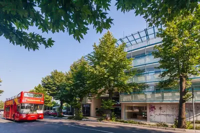 a red double decker bus parked in front of a building at Hotel Marina Palace, Affiliated by Meliá, Adults only in Nesebar