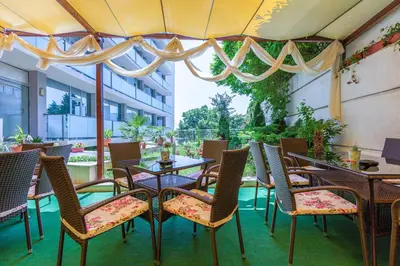 an outdoor patio with tables and chairs with a view at Hotel Marina Palace, Affiliated by Meliá, Adults only in Nesebar