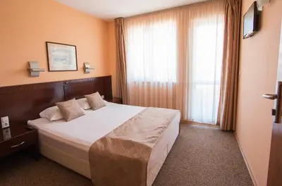 a hotel room with a bed and a window at Hotel Divesta - self check in in Varna City