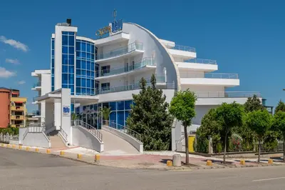 a large white building with stairs in front of it at Queen Nelly in Primorsko