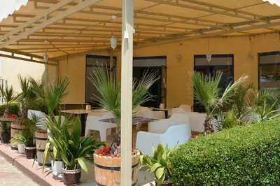 a patio with a table and chairs and plants at Rainbow 1 Holiday Complex in Sunny Beach