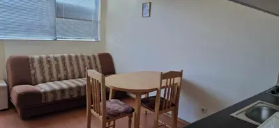 a room with a table and two chairs and a couch at Rainbow 1 Holiday Complex in Sunny Beach