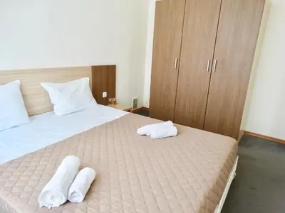 a bedroom with a bed with towels on it at Rainbow 1 Holiday Complex in Sunny Beach