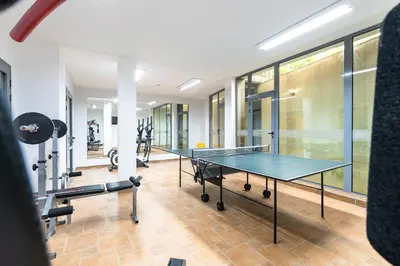 a gym with a ping pong table and tread machines at Sveti Dimitar Hotel in Primorsko