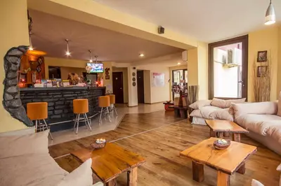 a living room with a couch and a bar at Coral Guest House in Obzor