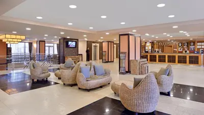 a lobby with couches and chairs in a building at Sol Nessebar Bay All Inclusive in Nesebar