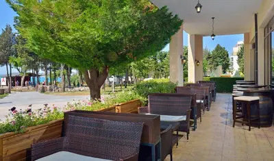a row of tables and chairs on a patio at Sol Nessebar Bay All Inclusive in Nesebar
