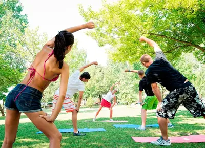 a group of people doing yoga in a park at Sol Nessebar Bay All Inclusive in Nesebar