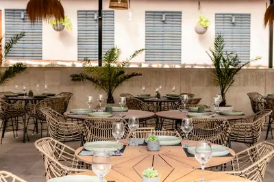a restaurant with tables and chairs and windows at Selena Beach Family Hotel - All Inclusive Light in Sozopol