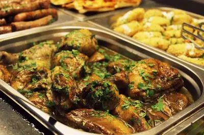 a tray of food with meat and other foods at Ariana Hotel in Kiten