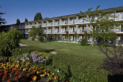 a building with a field of flowers in front of it at Continental Park Hotel in Sunny Beach