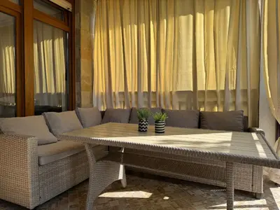 a table and a couch on a patio at Santa Marina Apartment 513 in Sozopol