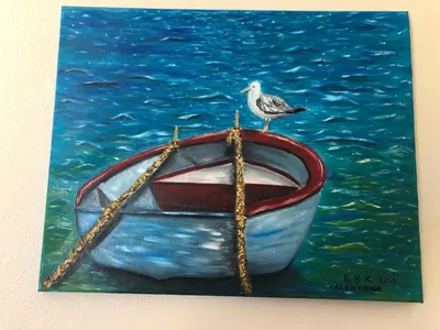 a bird sitting on top of a boat in the water at Family Hotel Avenue in Kiten