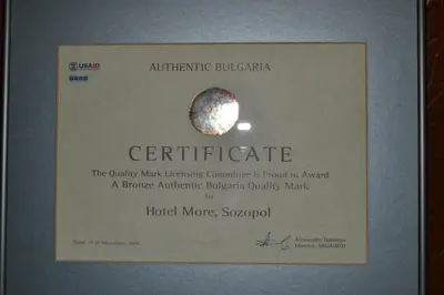 a framed certificate with a picture of a planet at More Family Hotel in Sozopol