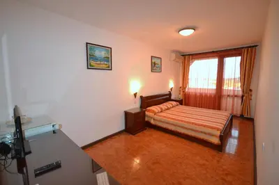 a hotel room with a bed and a window at More Family Hotel in Sozopol