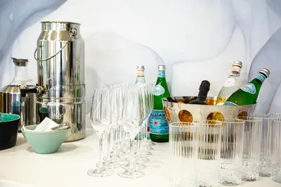 a group of wine glasses and bottles on a counter at Hotel Antea - By The Sea in Sozopol