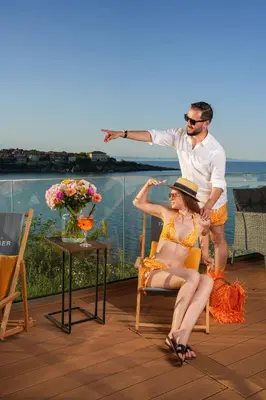 a man and a woman sitting on a deck at Hotel Antea - By The Sea in Sozopol
