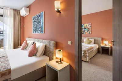 a hotel room with two beds and a mirror at Melia Sunny Beach All Inclusive in Sunny Beach