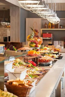 a buffet line with many plates of food at Melia Sunny Beach All Inclusive in Sunny Beach