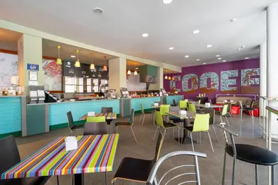 a restaurant with tables and chairs and a bar at MPM Hotel Kalina Garden - All Inclusive in Sunny Beach