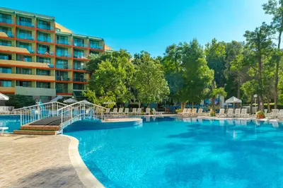 a swimming pool with a hotel in the background at MPM Hotel Kalina Garden - All Inclusive in Sunny Beach
