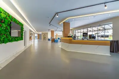 a large lobby with a reception desk in a building at Martinez Hotel All Inclusive in Sozopol