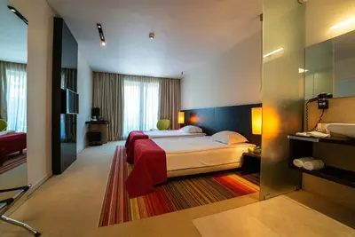 a hotel room with a bed and a mirror at mOdus Hotel in Varna City