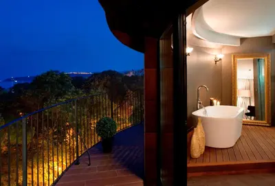 a bathroom with a bath tub on a balcony at mOdus Hotel in Varna City