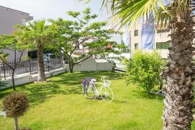 a bike parked in the grass in a yard at Royal Calisto Hotel in Sozopol