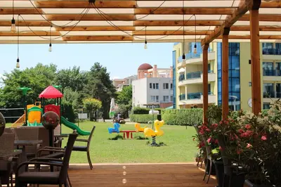 a patio with a playground with a play yard at Aparthotel Marina Holiday Club - All Inclusive & Free Parking in Pomorie